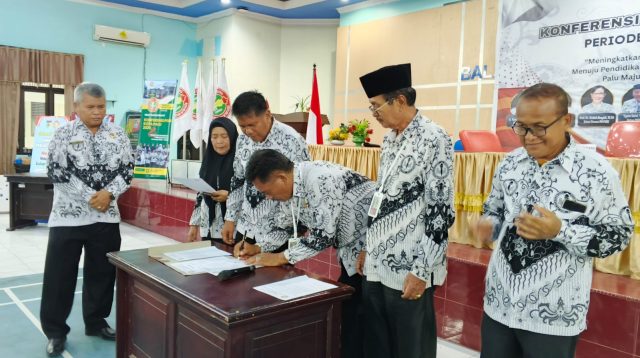 Ketua PGRI Kota Palu, Eddy Siswanto, menandatangani nota kesepakatan sebagai ketua terpilih periode 2025-2030. FOTO: Mohammad Rizal/Filesulawesi.com